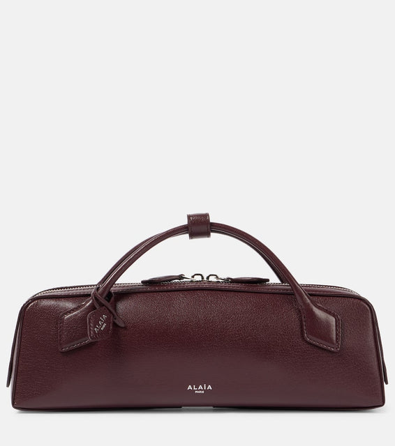 Alaia Le Teckel leather clutch. Shop Alaia Top-Handle Bags for women now.