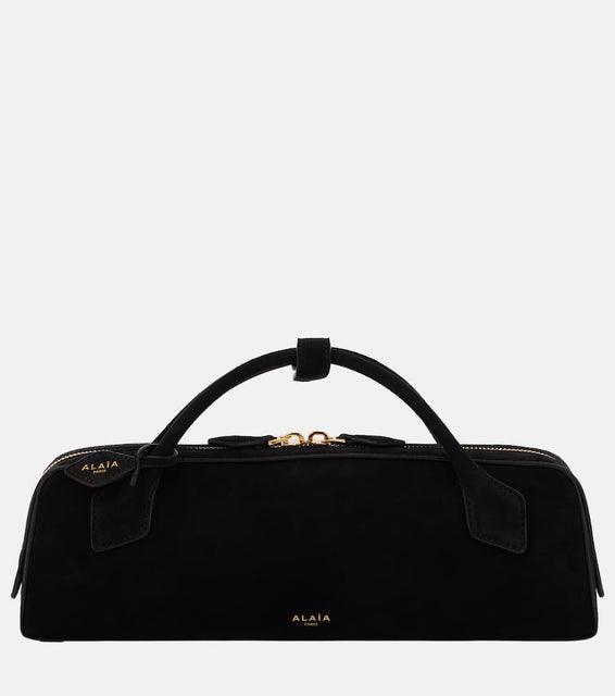 Alaia Le Teckel leather clutch. Shop Alaia Top-Handle Bags for women now.