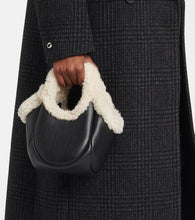 Coperni Swipe Mini faux fur-trimmed leather bucket bag