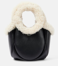 Coperni Swipe Mini faux fur-trimmed leather bucket bag. Shop Coperni Top-Handle Bags for women now.