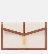 DeMellier Tokyo leather-trimmed canvas clutch. Shop DeMellier Clutches for women now.