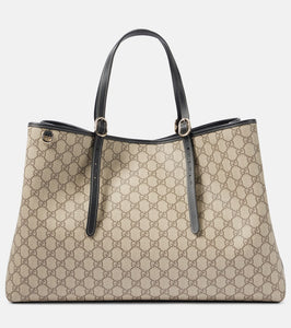 Gucci GG Canvas Large leather-trimmed tote bag. Shop Gucci Tote Bags for women now.