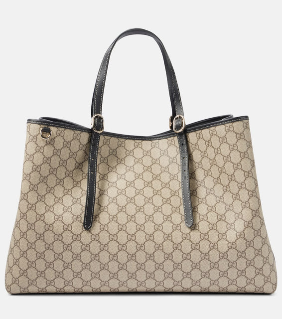 Gucci GG Canvas Large leather-trimmed tote bag. Shop Gucci Tote Bags for women now.