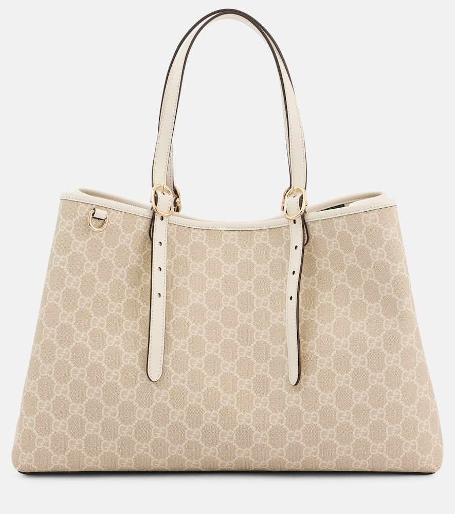 Gucci GG Emblem Medium leather-trimmed tote bag. Shop Gucci Tote Bags for women now.