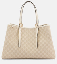 Gucci GG Emblem Medium leather-trimmed tote bag. Shop Gucci Tote Bags for women now.