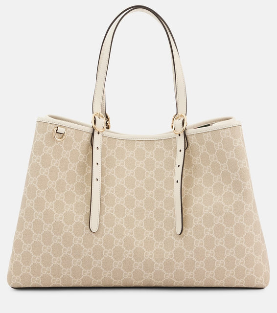 Gucci GG Emblem Medium leather-trimmed tote bag. Shop Gucci Tote Bags for women now.