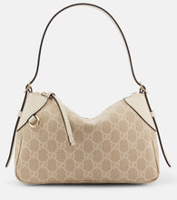 Gucci GG Emblem Small leather-trimmed shoulder bag. Shop Gucci Shoulder Bags for women now.