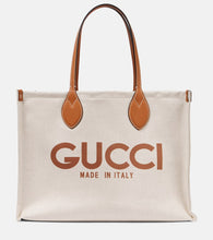 Gucci Medium logo leather-trimmed canvas tote bag. Shop Gucci Tote Bags for women now.