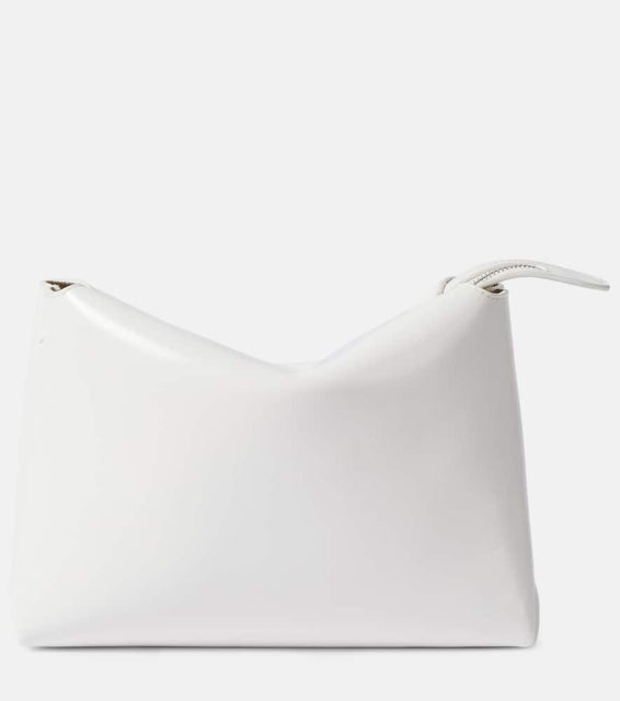Khaite Lina patent leather shoulder bag. Shop Khaite Clutches for women now.