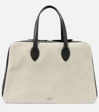 Khaite Maeve Large canvas and leather duffel bag. Shop Khaite Tote Bags for women now.