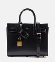 Saint Laurent Sac De Jour Nano leather tote. Shop Saint Laurent Top-Handle Bags for women now.