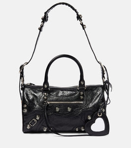 Balenciaga Neo Cagole leather duffel bag. Shop Balenciaga Shoulder Bags for women now.