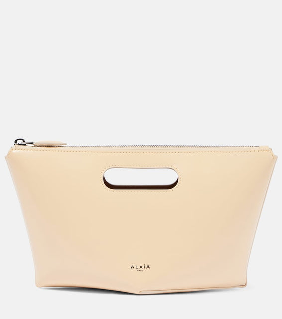 Alaia Folded Mini leather clutch. Shop Alaia Top-Handle Bags for women now.