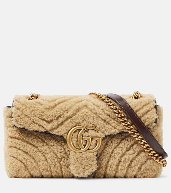 Gucci GG Marmont Small shearling shoulder bag. Shop Gucci Shoulder Bags for women now.