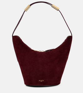 Alaia Shape Small suede and leather bucket bag. Shop Alaia Shoulder Bags for women now.