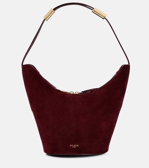 Alaia Shape Small suede and leather bucket bag. Shop Alaia Shoulder Bags for women now.