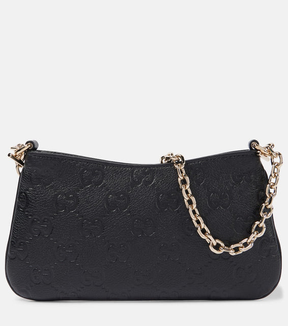 Gucci GG Super Mini debossed leather shoulder bag. Shop Gucci Shoulder Bags for women now.