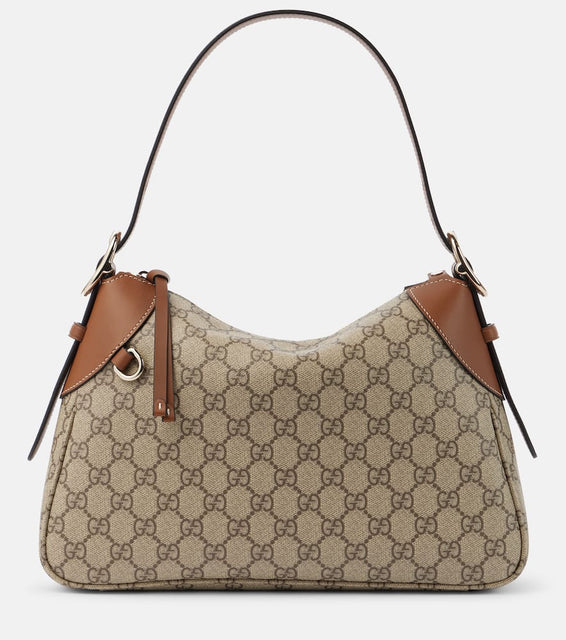 Gucci GG Canvas Medium leather-trimmed shoulder bag. Shop Gucci Shoulder Bags for women now.
