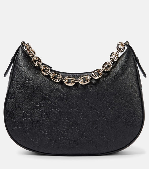 Gucci GG Medium debossed leather shoulder bag. Shop Gucci Top-Handle Bags for women now.