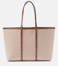 Valentino Garavani Rockstud Large canvas tote bag. Shop Valentino Garavani Tote Bags for women now.
