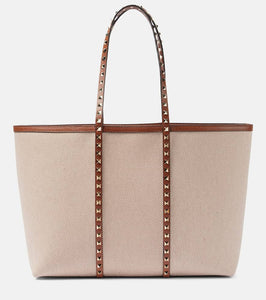 Valentino Garavani Rockstud Large canvas tote bag. Shop Valentino Garavani Tote Bags for women now.
