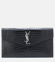 Saint Laurent Uptown embossed leather clutch. Shop Saint Laurent Clutches for women now.