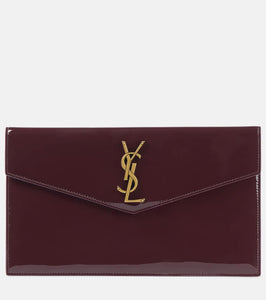 Saint Laurent Uptown patent leather clutch. Shop Saint Laurent Clutches for women now.