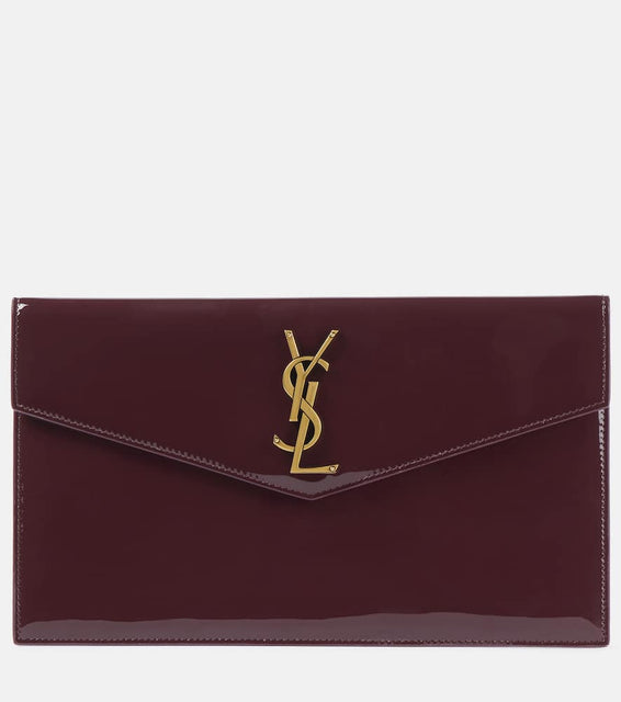 Saint Laurent Uptown patent leather clutch. Shop Saint Laurent Clutches for women now.