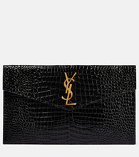 Saint Laurent Uptown patent leather clutch. Shop Saint Laurent Clutches for women now.