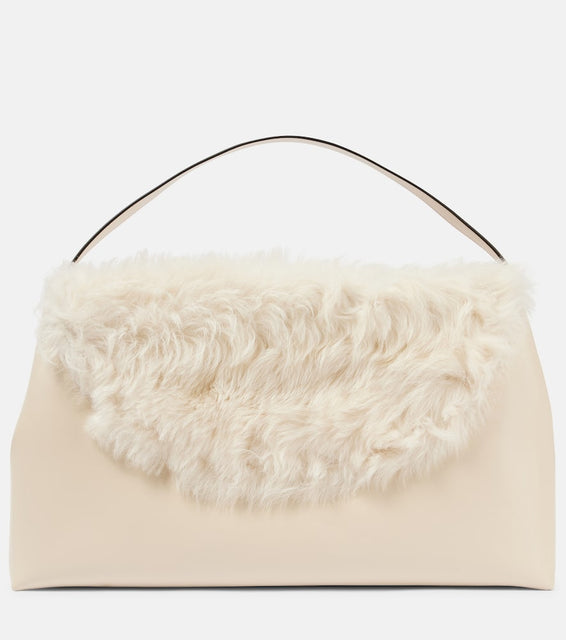 Toteme T-Lock Large shearling-trimmed shoulder bag. Shop Toteme Top-Handle Bags for women now.
