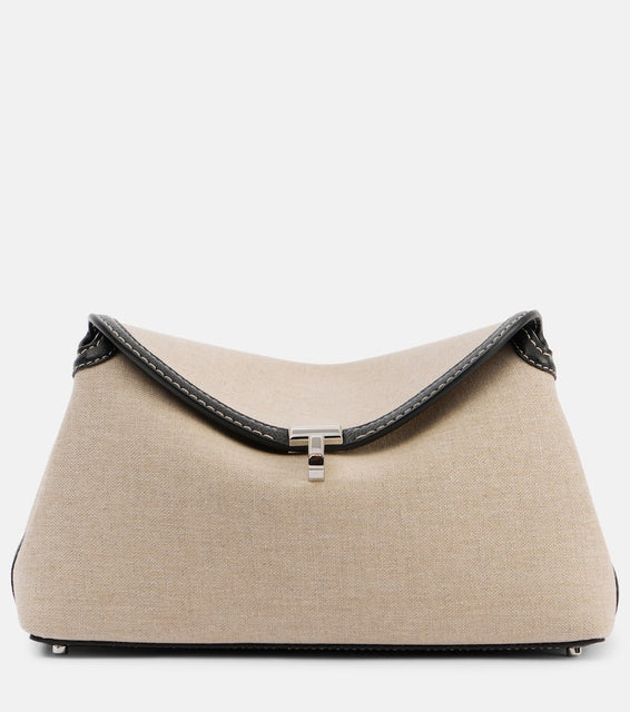 Toteme T-Lock leather-trimmed canvas clutch. Shop Toteme Clutches for women now.