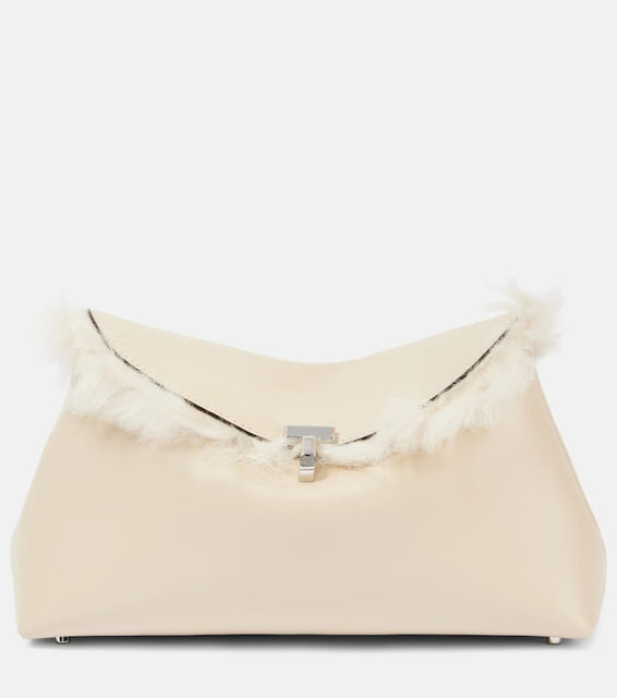 Toteme T-Lock shearling-lined leather clutch. Shop Toteme Clutches for women now.