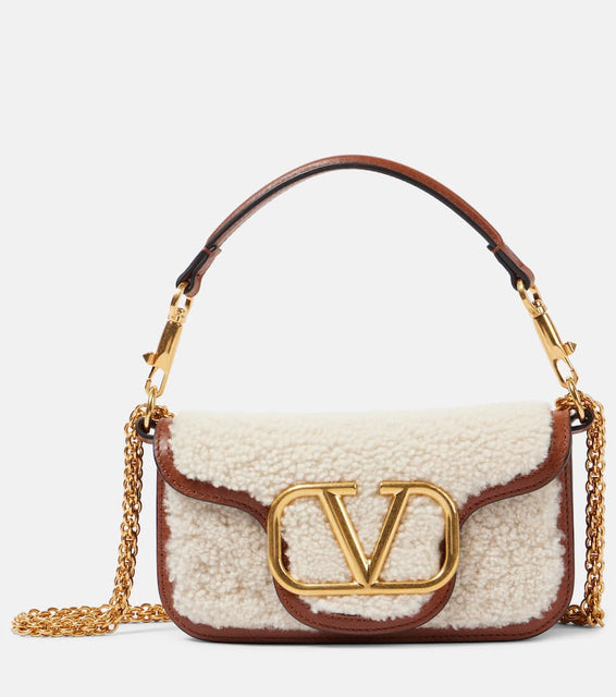 Valentino Garavani Loc√É¬≤ Small shearling and leather shoulder bag. Shop Valentino Garavani Top-Handle Bags for women now.