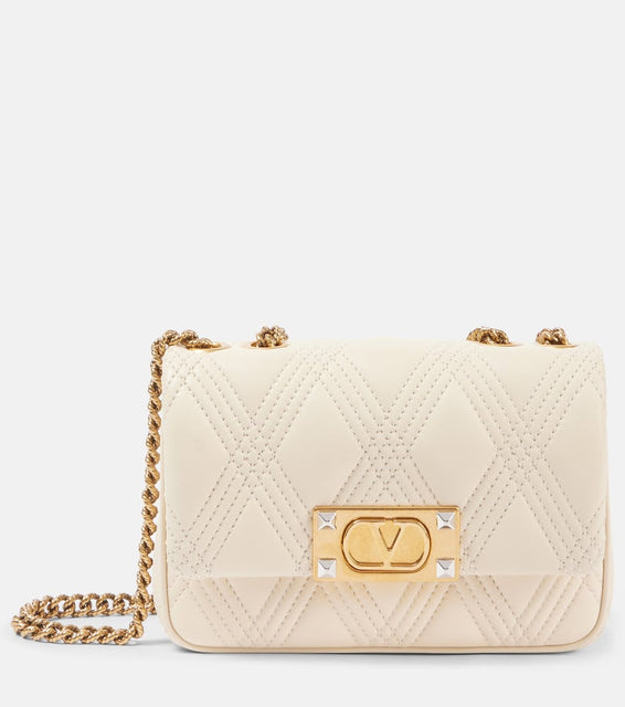 Valentino Garavani Quiltie 67 Small leather shoulder bag. Shop Valentino Garavani Crossbody Bags for women now.