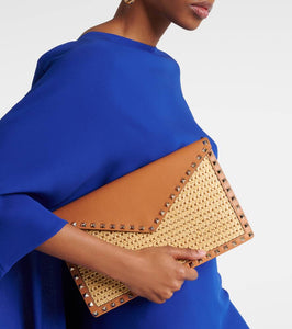 Valentino Garavani Rockstud Large leather-trimmed raffia clutch