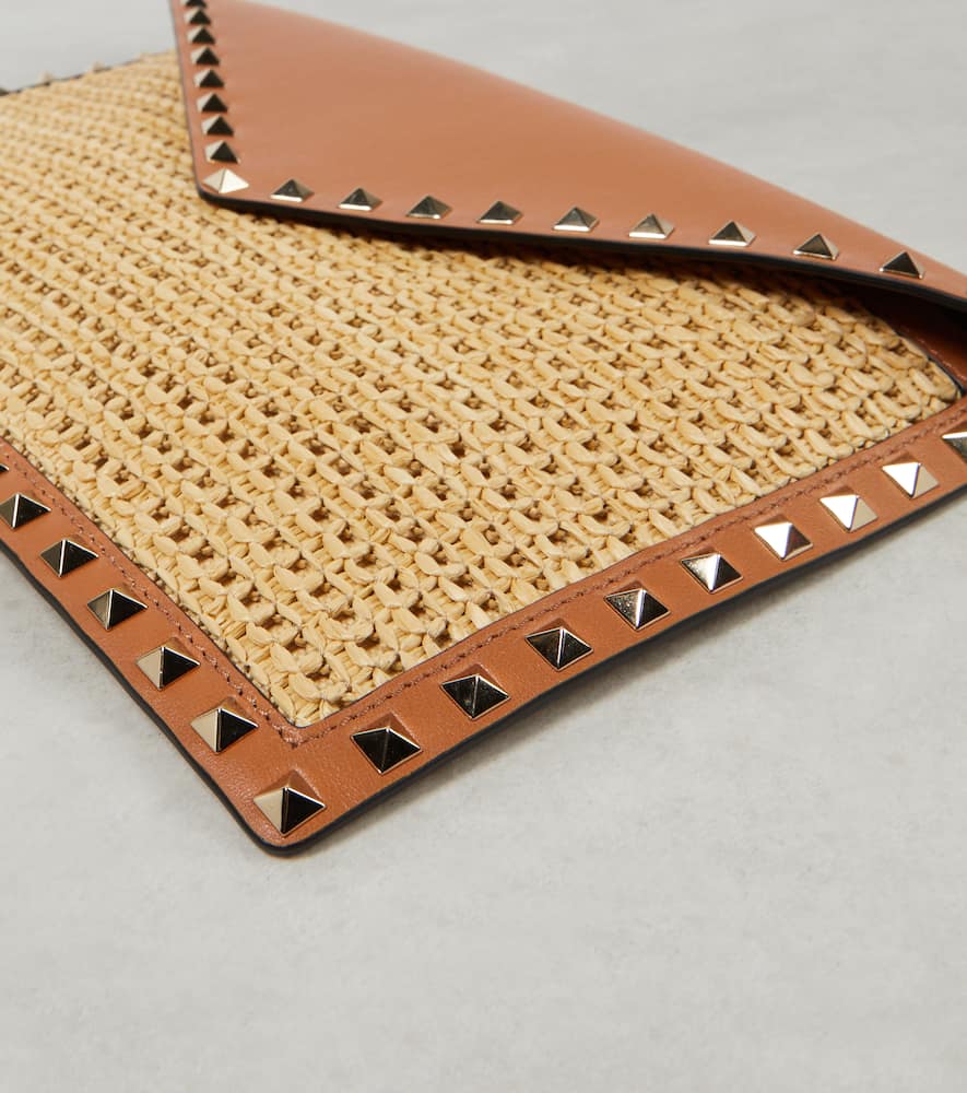Valentino Garavani Rockstud Large leather-trimmed raffia clutch