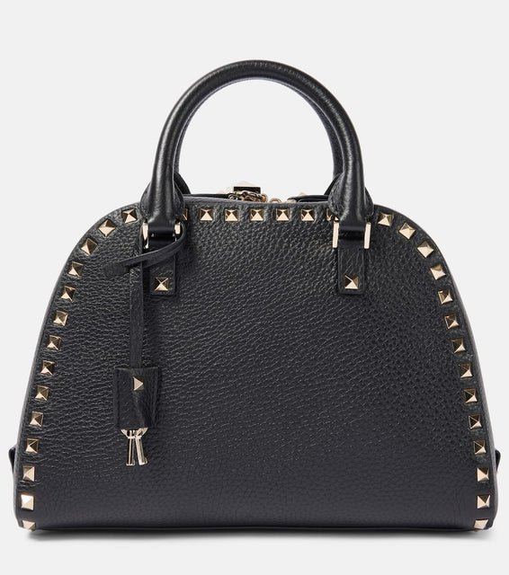 Valentino Garavani Rockstud Medium leather tote bag. Shop Valentino Garavani Top-Handle Bags for women now.