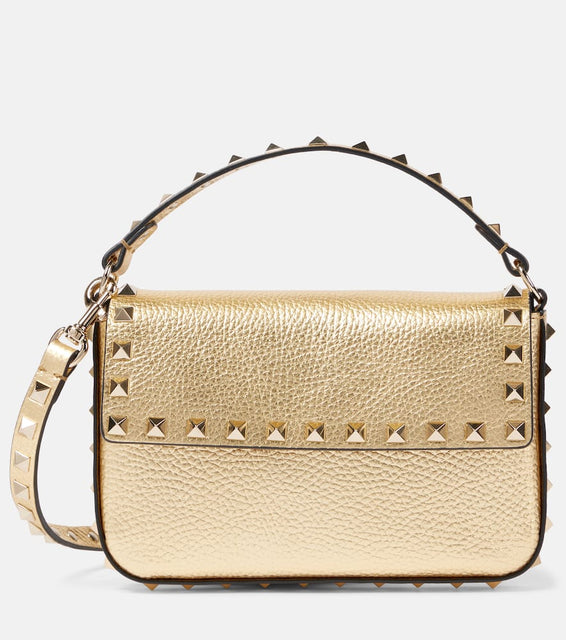 Valentino Garavani Rockstud Mini metallic leather shoulder bag. Shop Valentino Garavani Top-Handle Bags for women now.
