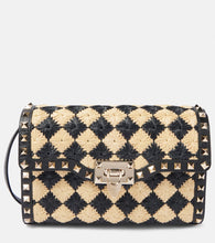 Valentino Garavani Rockstud Small raffia-effect shoulder bag. Shop Valentino Garavani Crossbody Bags for women now.