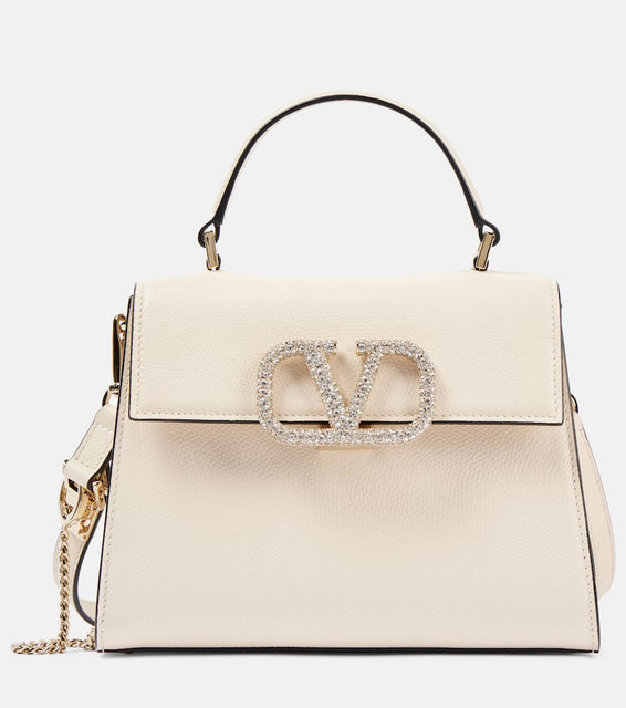 Valentino Garavani VSling Small embellished leather tote bag. Shop Valentino Garavani Top-Handle Bags for women now.