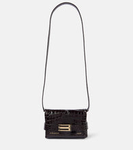 Victoria Beckham Mini croc-effect leather clutch. Shop Victoria Beckham Clutches for women now.