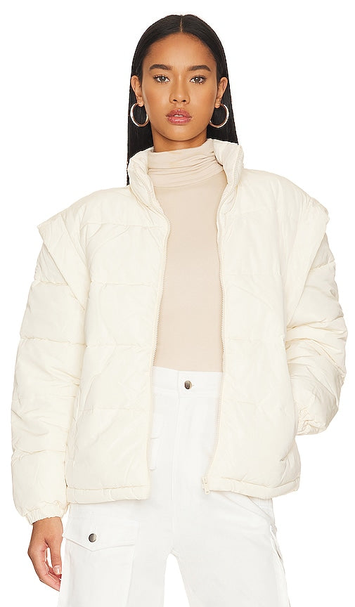 WeWoreWhat Snap Off Sleeve Puffer Jacket in Ivory - WeWoreWhat - Doudoune à manches boutonnées en ivoire - WeWoreWhat 象牙色按扣袖填充夹克 - WeWoreWhat Pufferjacke mit abknöpfbaren Ärmeln in Elfenbein - WeWoreWhat 스냅 오프 슬리브 퍼퍼 재킷 - WeWoreWhat Piumino con maniche a scatto in avorio